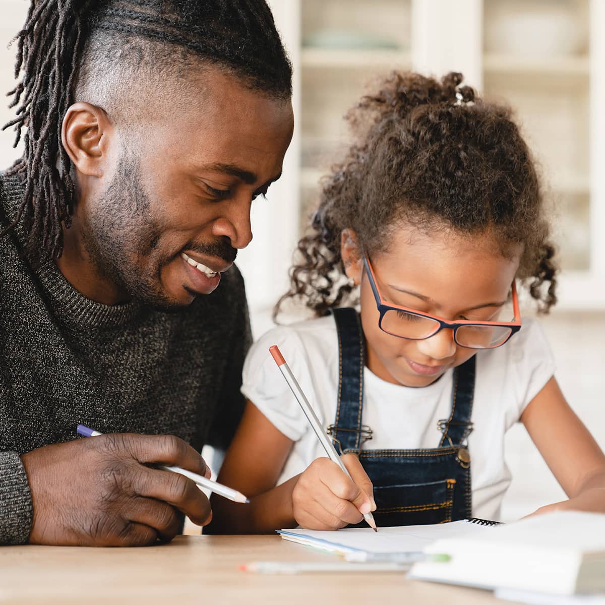 Father helping daughter with homework